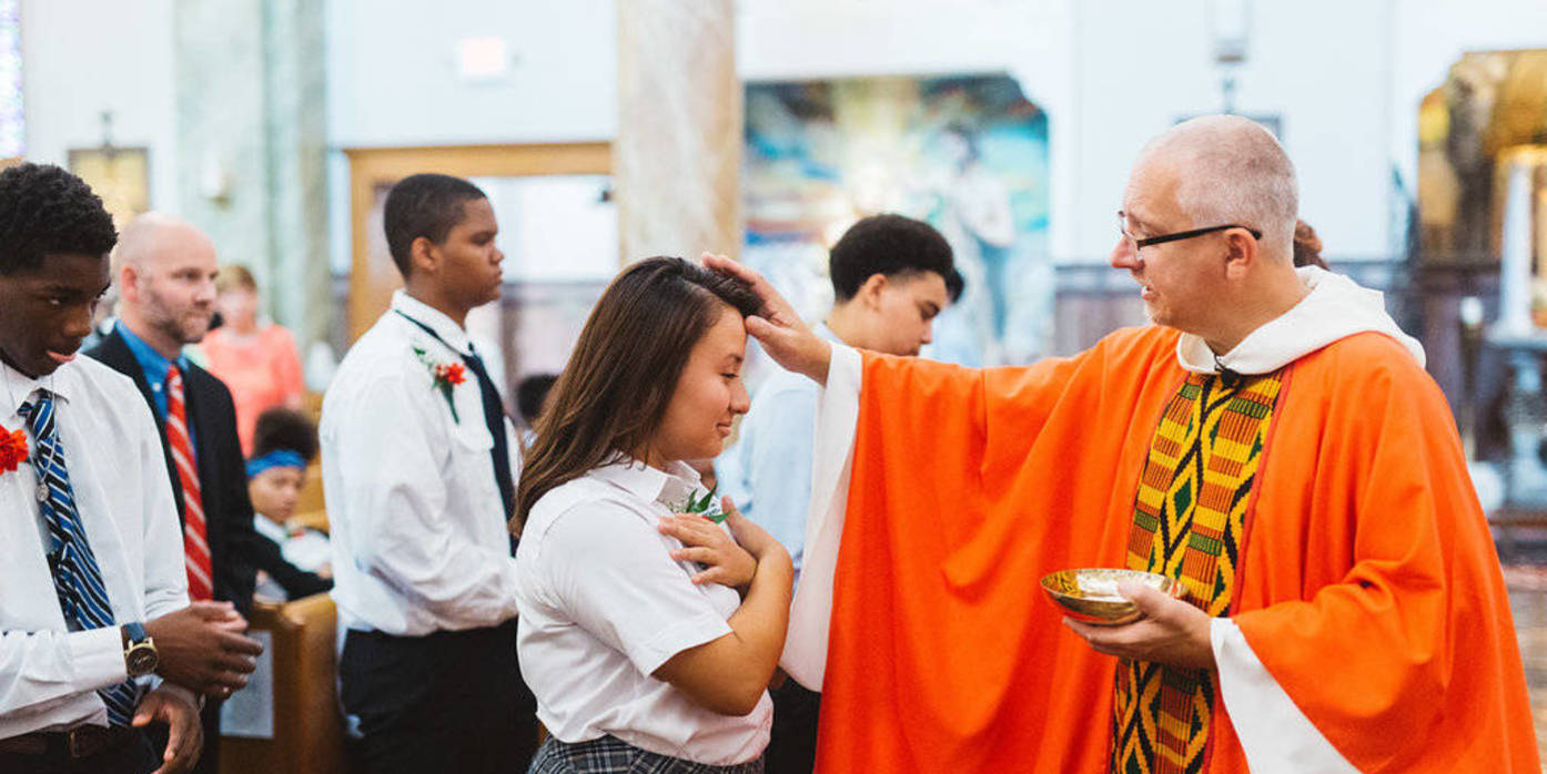 priest anoints students